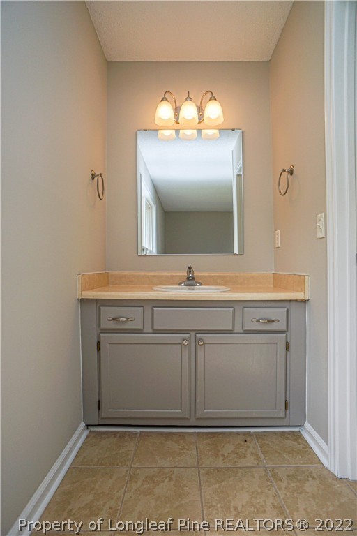974 Rim Road Fayetteville, NC 28314 - Photo 31 of 40 a bathroom with a sink and a mirror