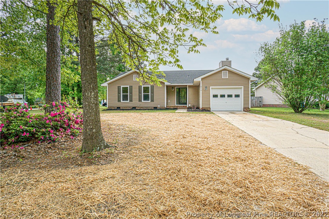 974 Rim Road Fayetteville, NC 28314 - Photo 40 of 40 a front view of a house with a garden and trees