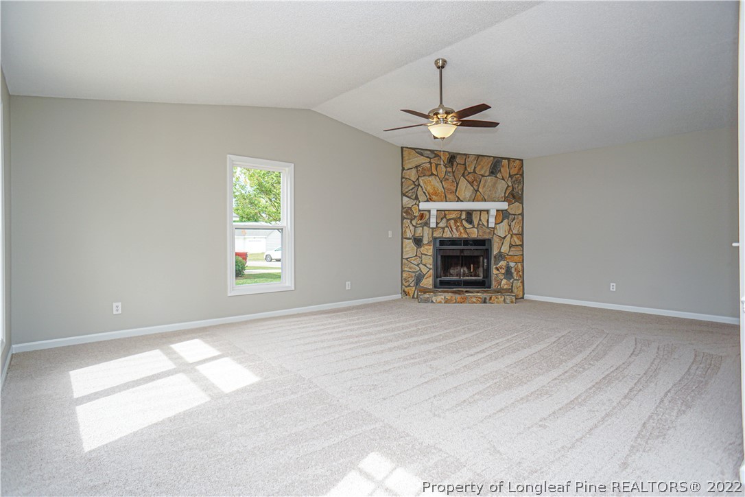 974 Rim Road Fayetteville, NC 28314 - Photo 7 of 40 an empty room with chandelier fan and windows