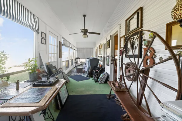 a view of a livingroom with furniture and a floor to ceiling window