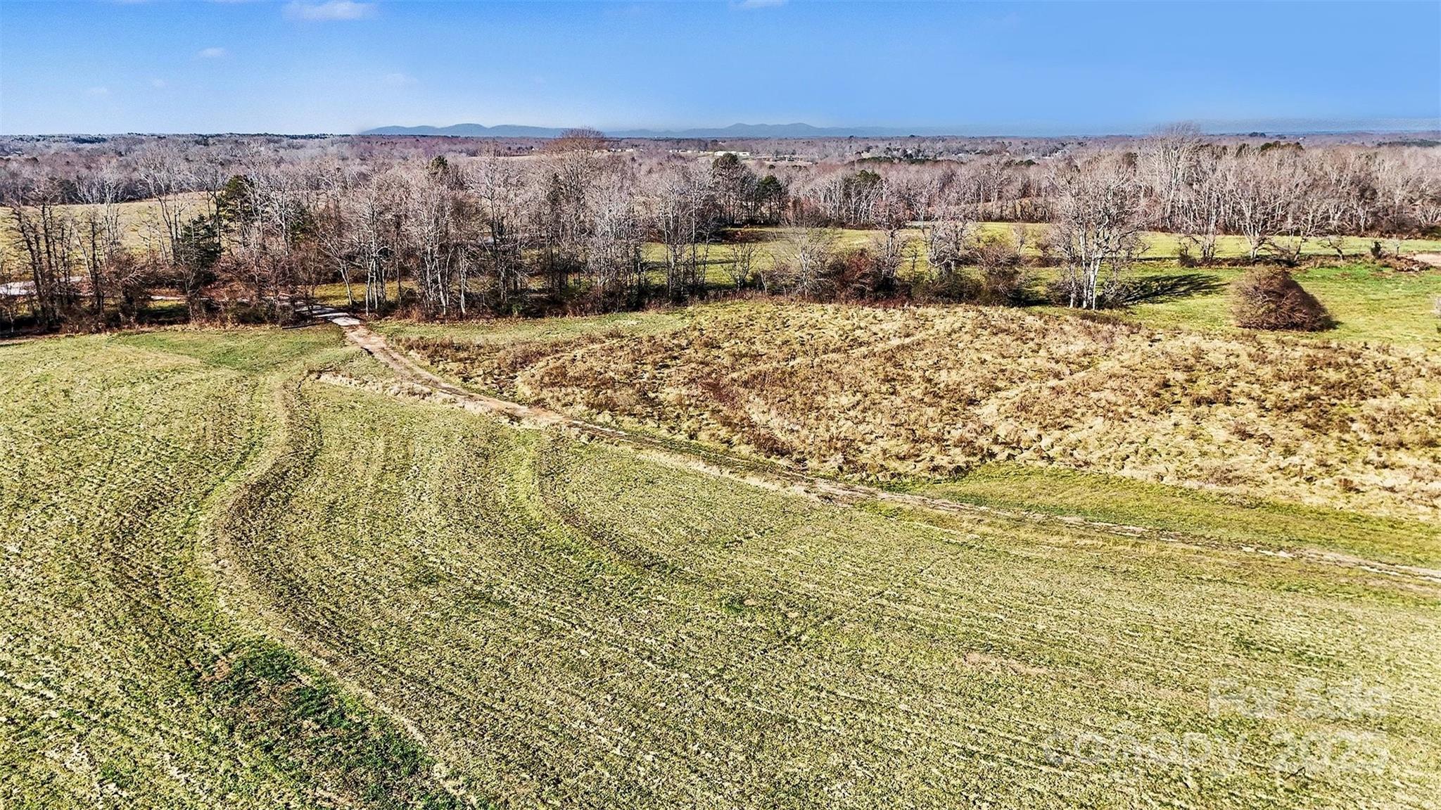 498 Carolina Ridge Road Gaffney, SC 29341 - Photo 14 of 17 a view of swimming pool of water with lawn chairs and large trees