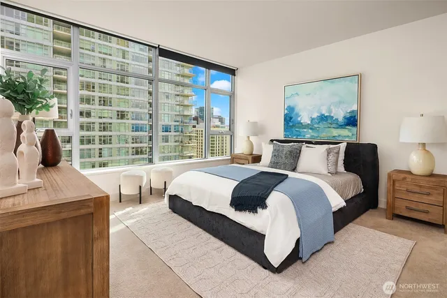 a bedroom with a large bed and a window