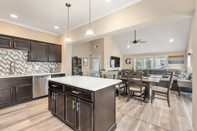 a large kitchen with a table and chairs