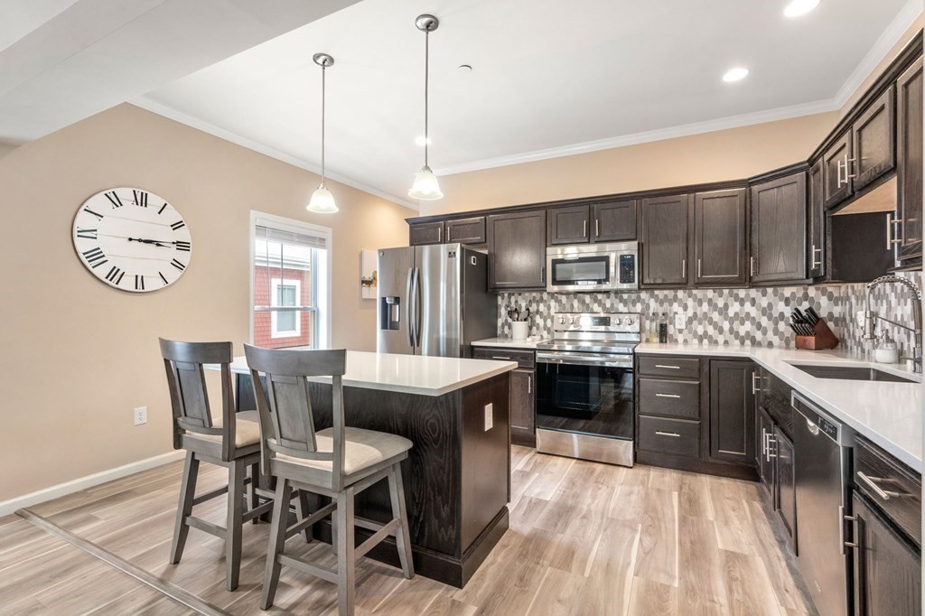 1 Elm Street, Unit 4 Boston, MA 02122 - Photo 6 of 15 a large kitchen with a table and chairs