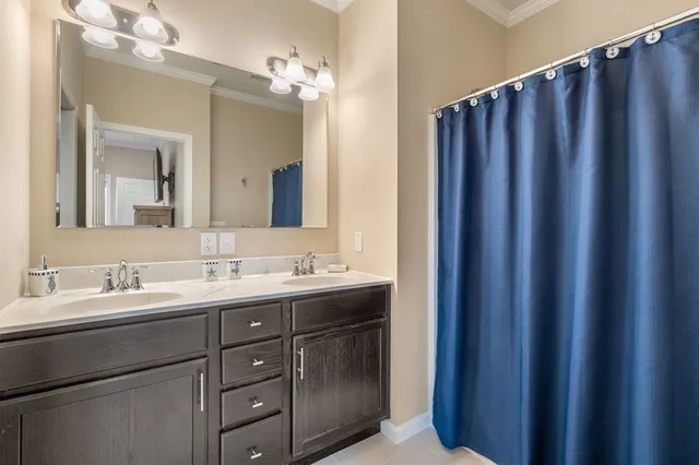 a bathroom with a double vanity sink and mirror