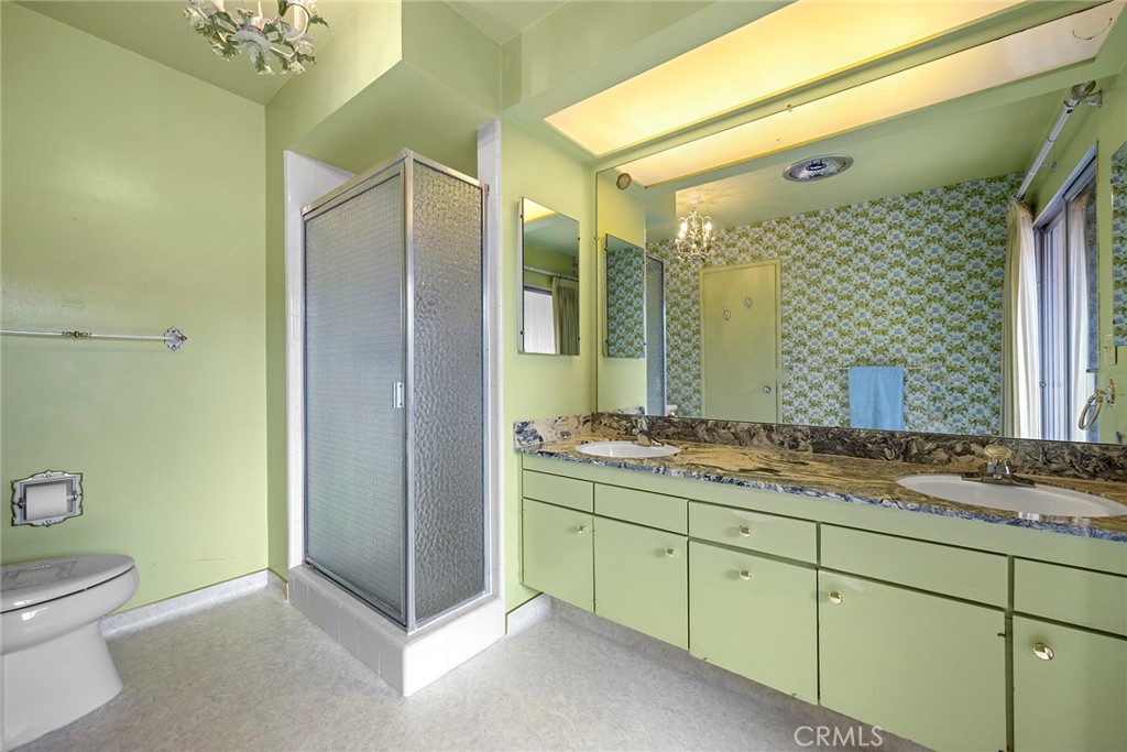 3116 Firethorne Avenue Fullerton, CA 92835 - Photo 18 of 32 a bathroom with a granite countertop sink mirror vanity and toilet