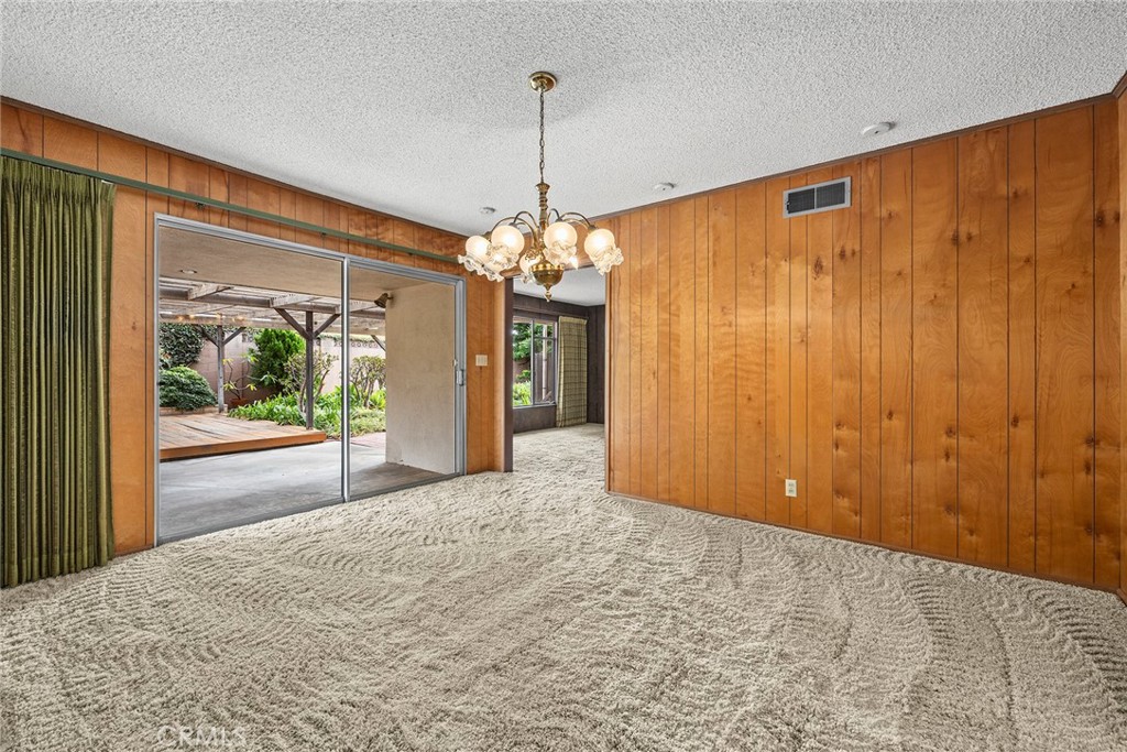 3116 Firethorne Avenue Fullerton, CA 92835 - Photo 4 of 32 a view of a hallway with wooden floor and a chandelier