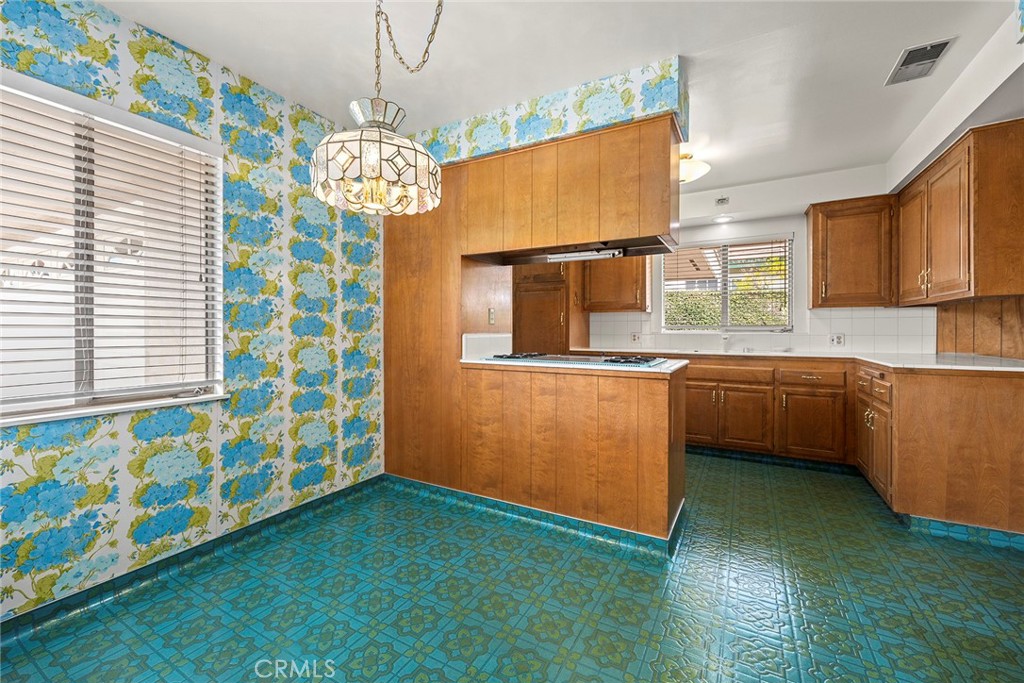 3116 Firethorne Avenue Fullerton, CA 92835 - Photo 8 of 32 a kitchen with stainless steel appliances a sink a stove a microwave a refrigerator and cabinets