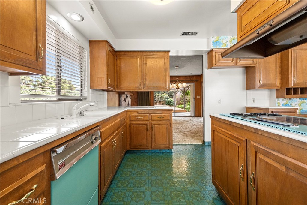 3116 Firethorne Avenue Fullerton, CA 92835 - Photo 10 of 32 a kitchen with stainless steel appliances granite countertop a sink a stove and a refrigerator