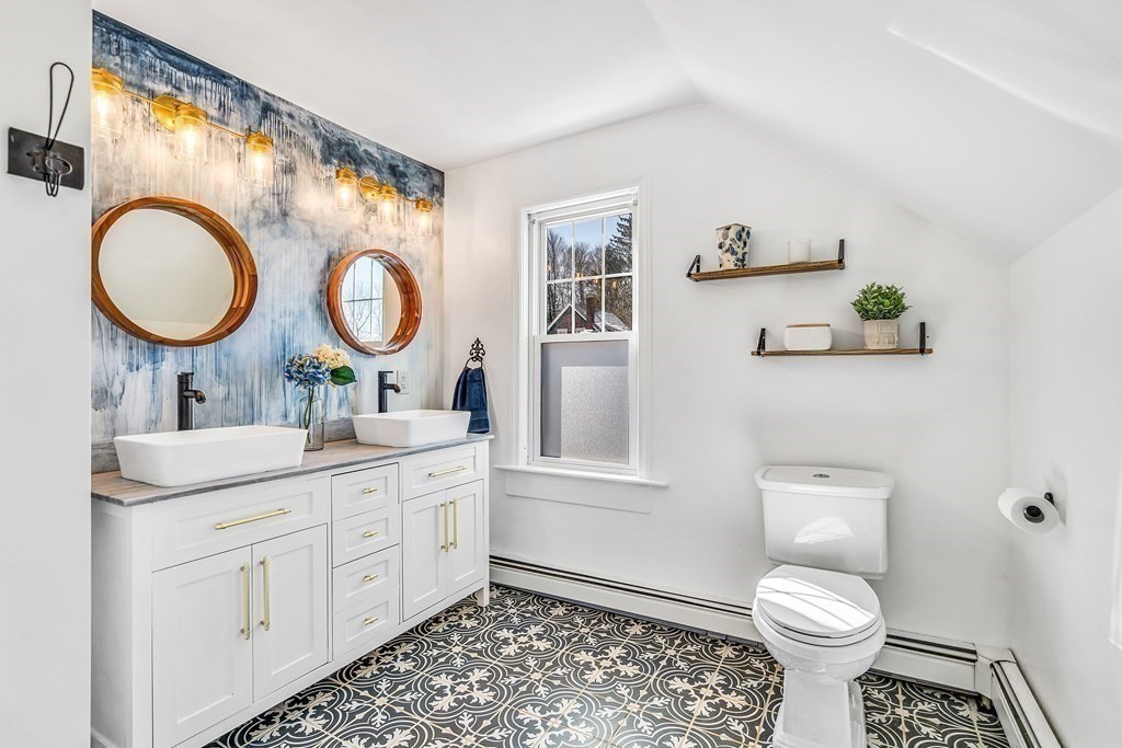 37 Acre Street Clinton, MA 01510 - Photo 26 of 38 a bathroom with a toilet a sink and a mirror