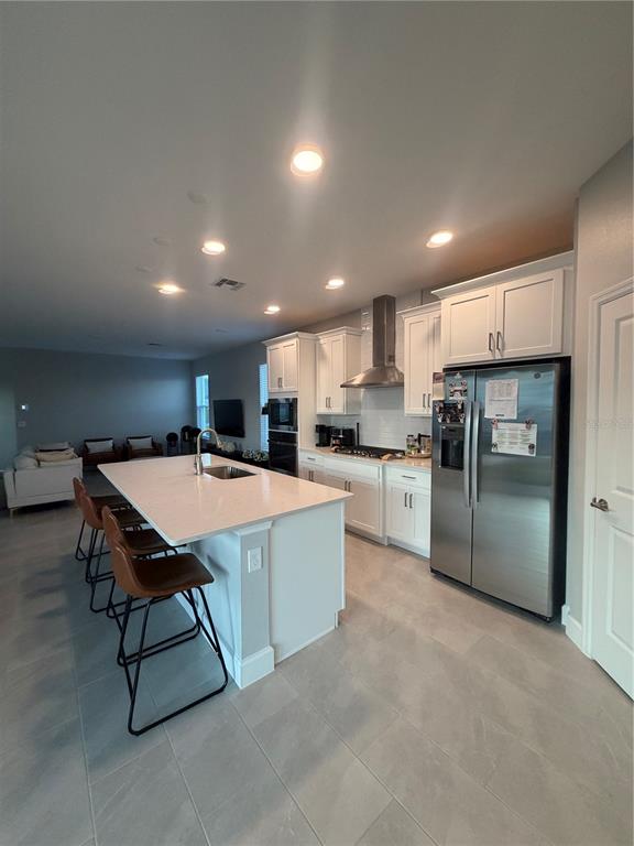 1389 Lumpini Street St. Cloud, FL 34771 - Photo 12 of 32 a kitchen with a table and chairs