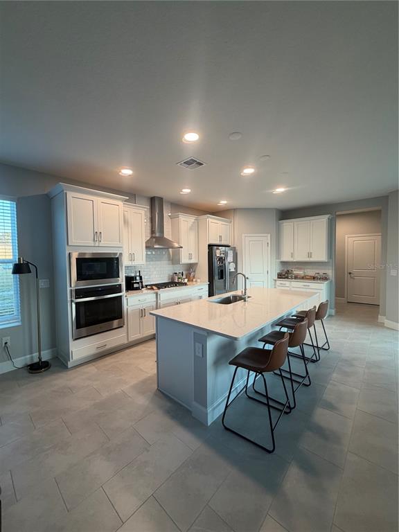 1389 Lumpini Street St. Cloud, FL 34771 - Photo 13 of 32 a kitchen with a table and chairs in it