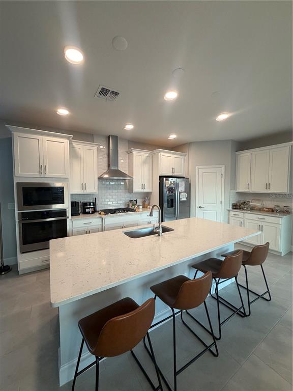 1389 Lumpini Street St. Cloud, FL 34771 - Photo 14 of 32 a kitchen with a dining table chairs and refrigerator