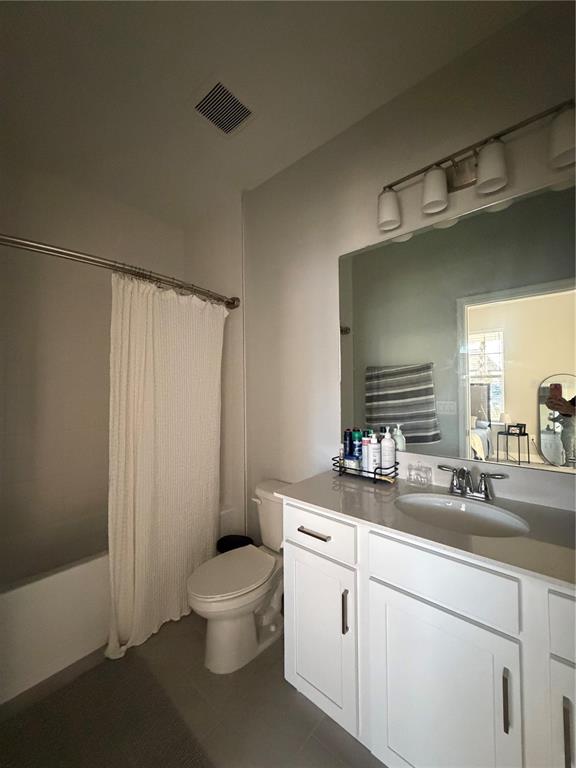 1389 Lumpini Street St. Cloud, FL 34771 - Photo 16 of 32 a bathroom with a double vanity sink toilet and a mirror