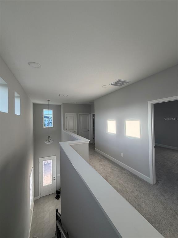 1389 Lumpini Street St. Cloud, FL 34771 - Photo 17 of 32 a view of a hallway to room and kitchen