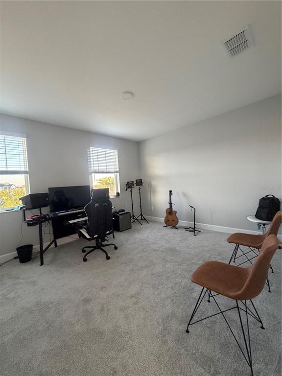 1389 Lumpini Street St. Cloud, FL 34771 - Photo 19 of 32 a living room with furniture and a chair