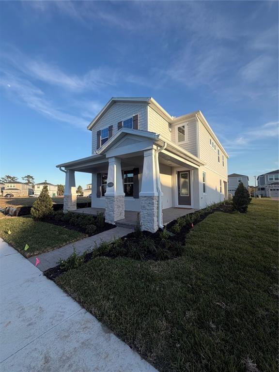 1389 Lumpini Street St. Cloud, FL 34771 - Photo 2 of 32 a front view of a house with a garden