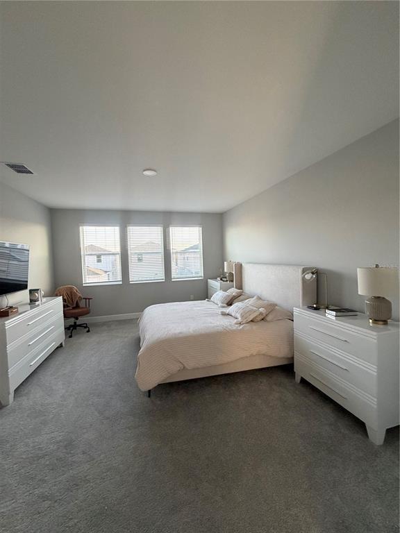 1389 Lumpini Street St. Cloud, FL 34771 - Photo 24 of 32 a spacious bedroom with a bed and a couch