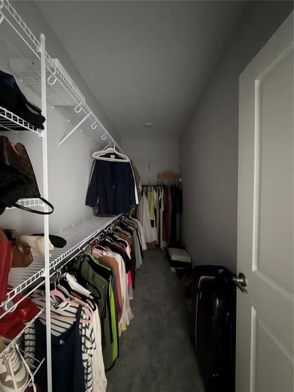 1389 Lumpini Street St. Cloud, FL 34771 - Photo 26 of 32 a view of walk in closet with clothes and shoes