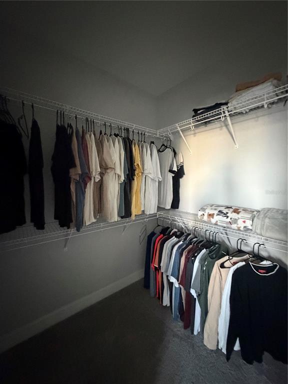 1389 Lumpini Street St. Cloud, FL 34771 - Photo 27 of 32 a view of walk in closet with clothes and shoes