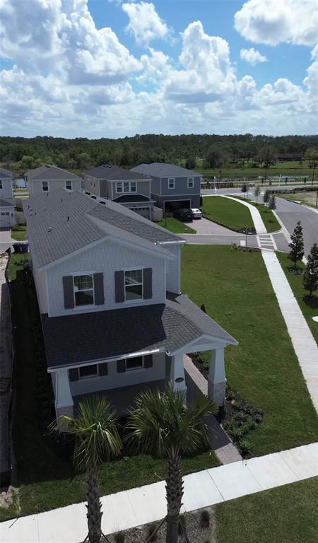 1389 Lumpini Street St. Cloud, FL 34771 - Photo 30 of 32 a view of a house with a yard