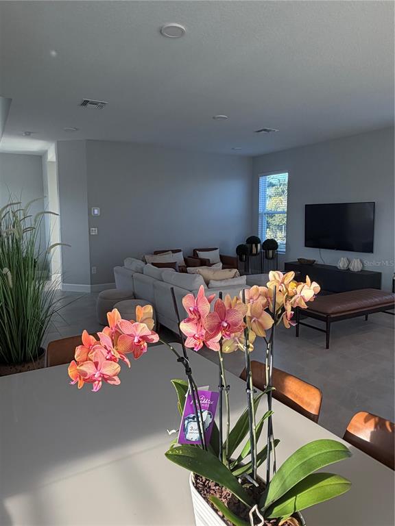 1389 Lumpini Street St. Cloud, FL 34771 - Photo 5 of 32 a living room filled with furniture and a flat screen tv