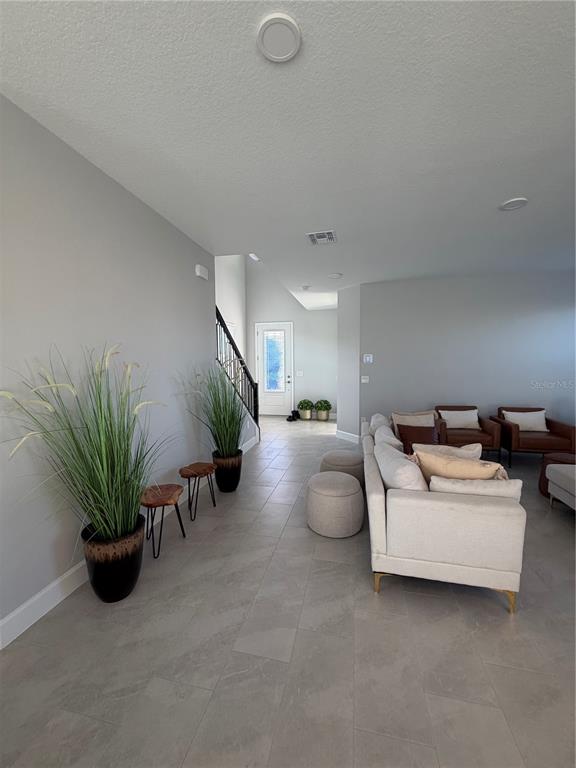 1389 Lumpini Street St. Cloud, FL 34771 - Photo 7 of 32 a living room with furniture and a potted plant