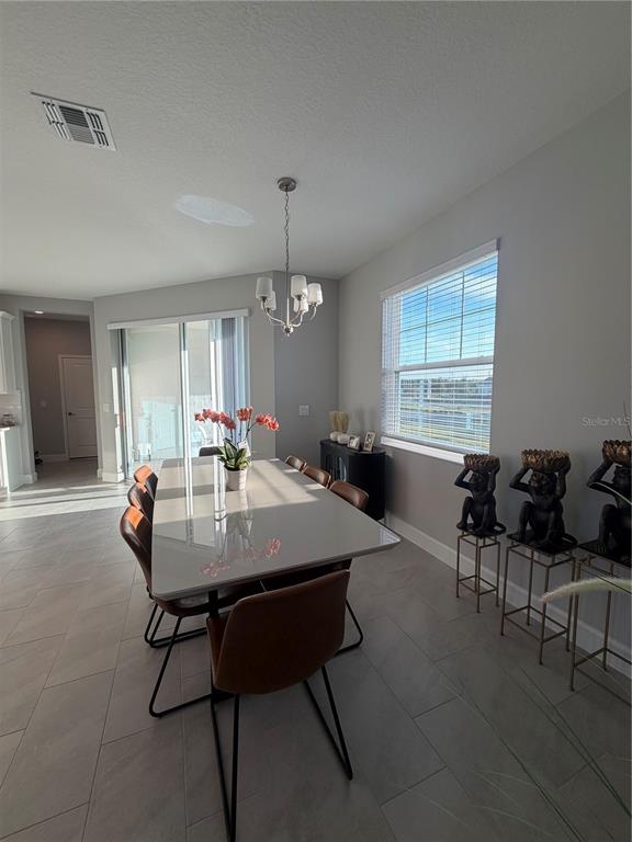 1389 Lumpini Street St. Cloud, FL 34771 - Photo 9 of 32 a view of a dining room with furniture and window