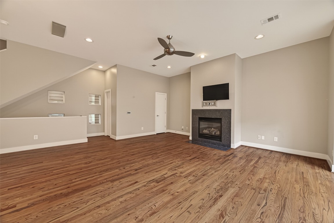 1112 Columbus Street, Unit B Houston, TX 77019 - Photo 5 of 31 a view of an empty room with wooden floor fireplace and a window