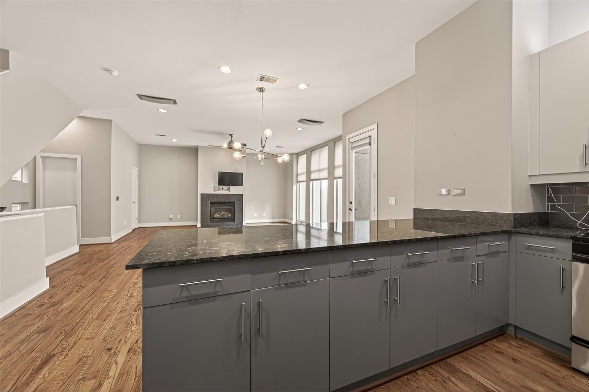 1112 Columbus Street, Unit B Houston, TX 77019 - Photo 7 of 31 a kitchen with granite countertop a sink and white cabinets