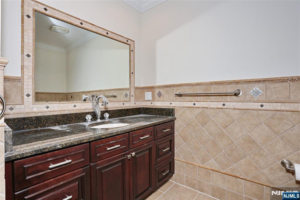 65 Ross Avenue Demarest, NJ 07627 - Photo 27 of 48 a bathroom with a granite countertop sink and a mirror