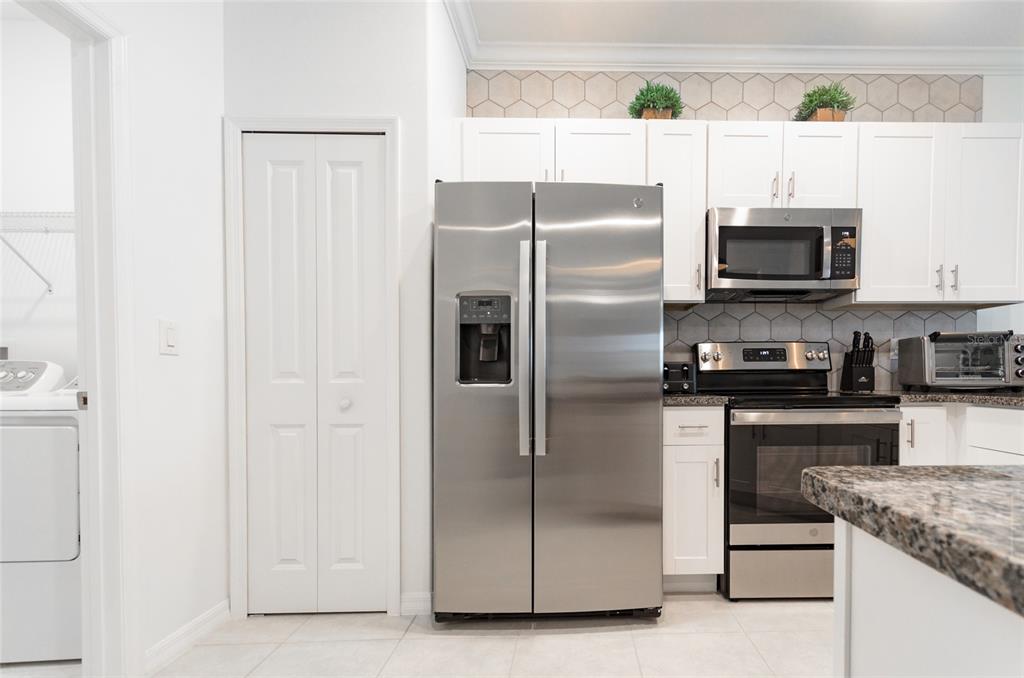 6736 Ripple Pond Loop Zephyrhills, FL 33541 - Photo 13 of 40 a kitchen with granite countertop a refrigerator and a stove