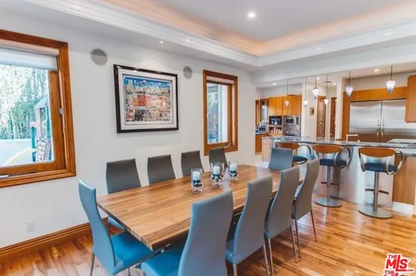 a view of a dining room with furniture window and wooden floor