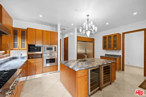 a kitchen with stainless steel appliances granite countertop a stove oven and a refrigerator