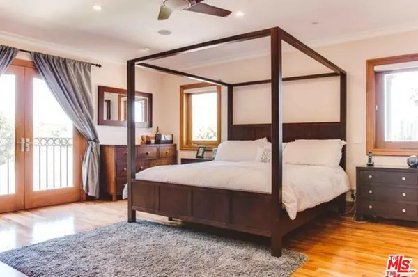 a bedroom with a large bed and a large window