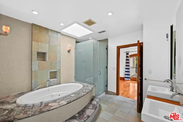 a bathroom with a tub and shower
