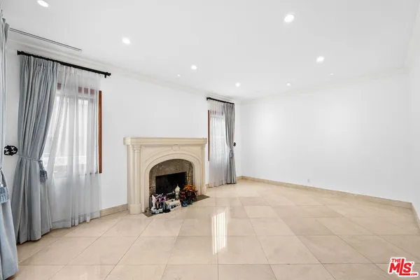 a view of an empty room with furniture and a fireplace