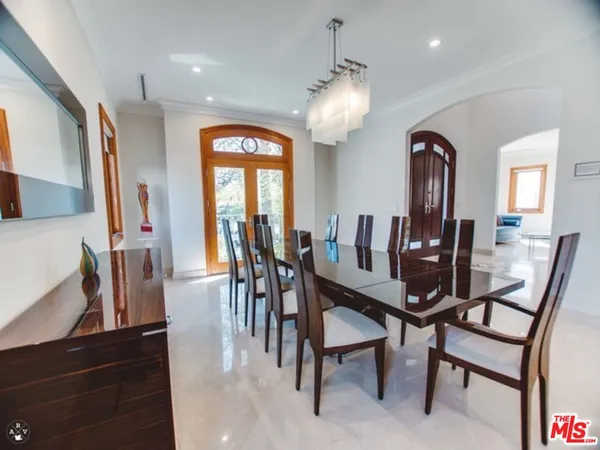 a view of a dining room with furniture and a large window