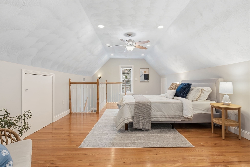 5 Pickett Street Beverly, MA 01915 - Photo 13 of 30 a spacious bedroom with a bed and a chandelier
