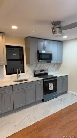 a kitchen with stainless steel appliances granite countertop a sink and a stove top oven