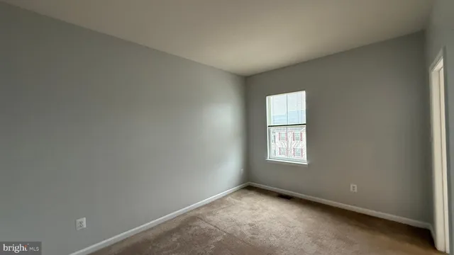 an empty room with window and windows