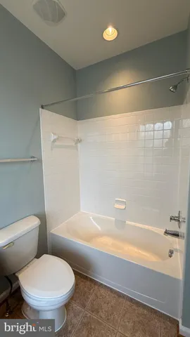 a bathroom with a toilet and a bathtub