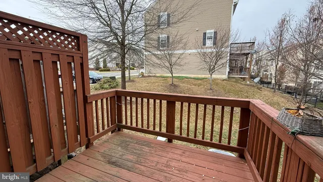a view of balcony with wooden floor and fence