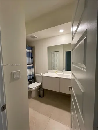 a bathroom with a bathtub sink and toilet