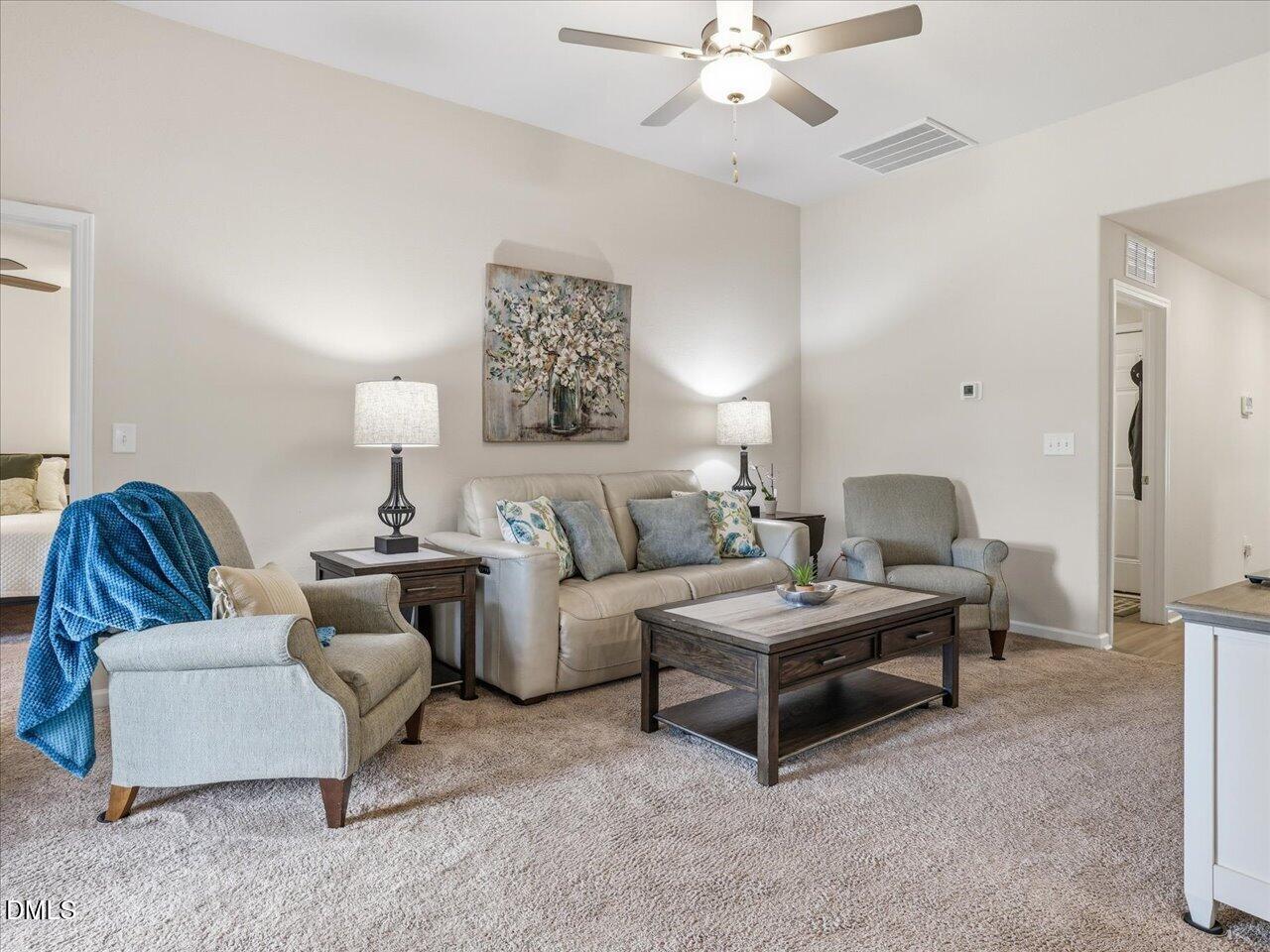 90 Barnsley Road Angier, NC 27501 - Photo 9 of 40 a living room with furniture and a chandelier