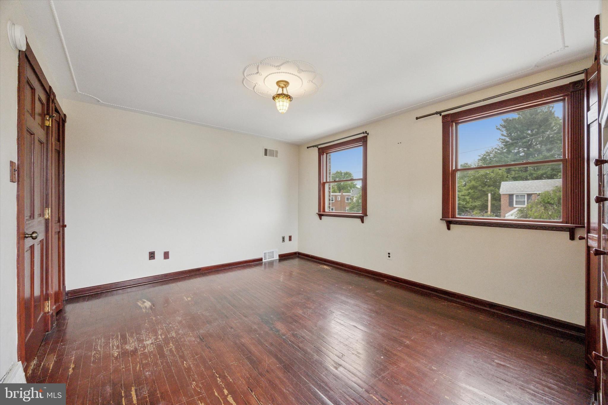 547 Overlook Road Philadelphia, PA 19128 - Photo 15 of 24 an empty room with wooden floor and windows