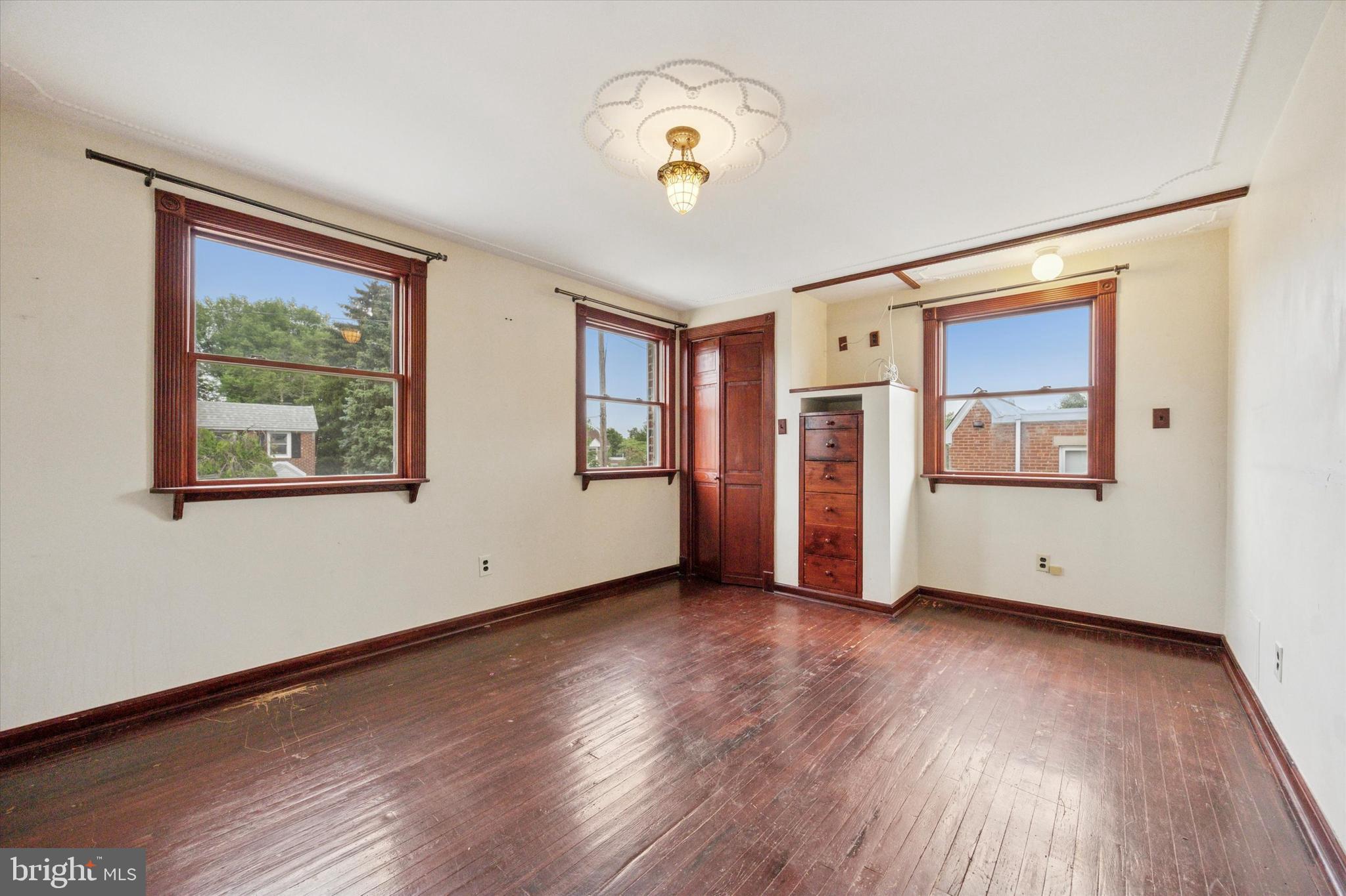 547 Overlook Road Philadelphia, PA 19128 - Photo 16 of 24 a view of an empty room with window and wooden floor