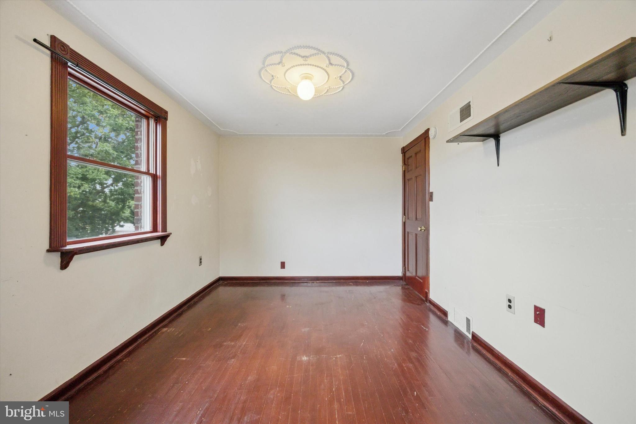 547 Overlook Road Philadelphia, PA 19128 - Photo 18 of 24 an empty room with wooden floor and windows