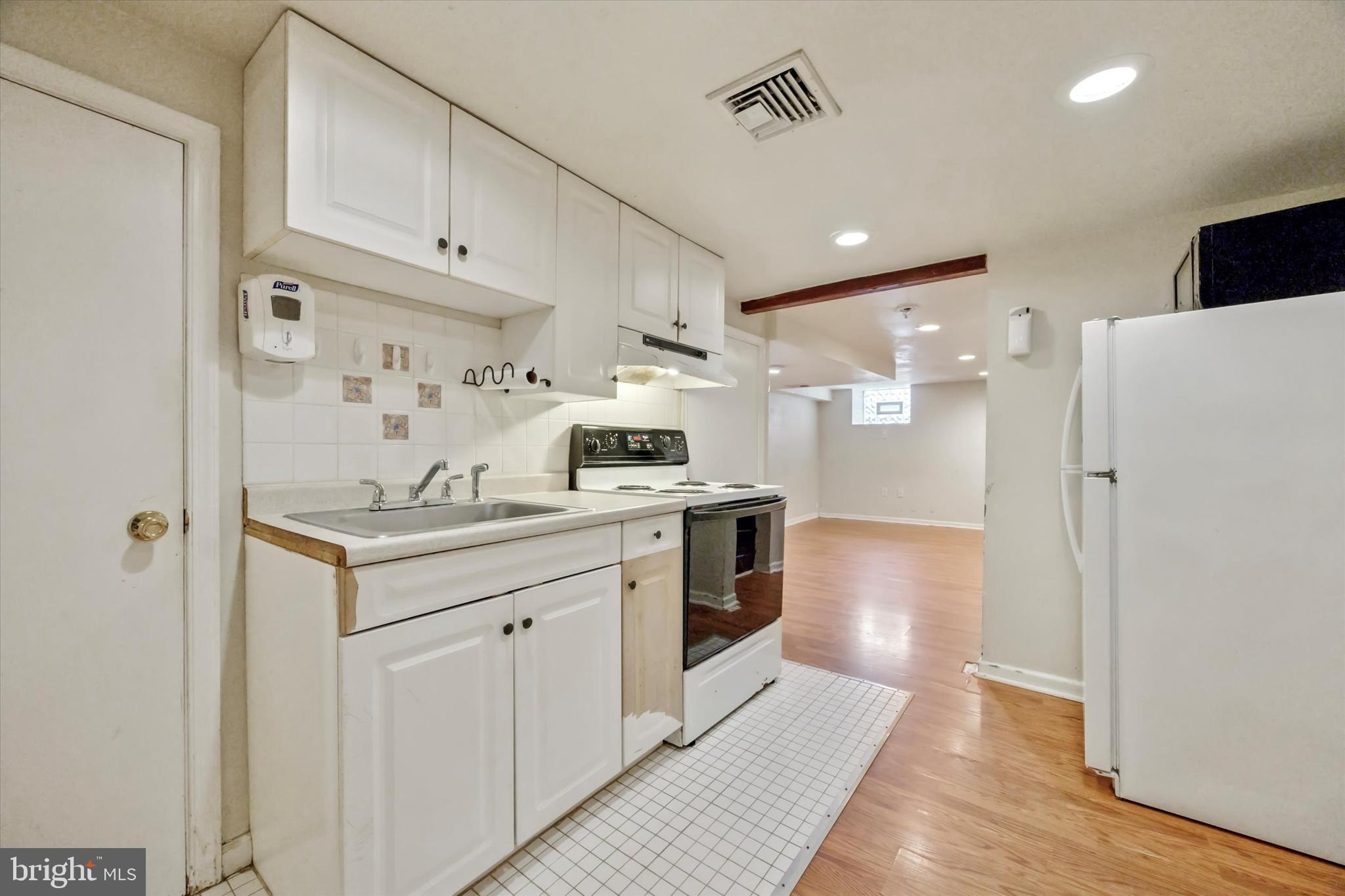547 Overlook Road Philadelphia, PA 19128 - Photo 20 of 24 a kitchen with white cabinets and stainless steel appliances