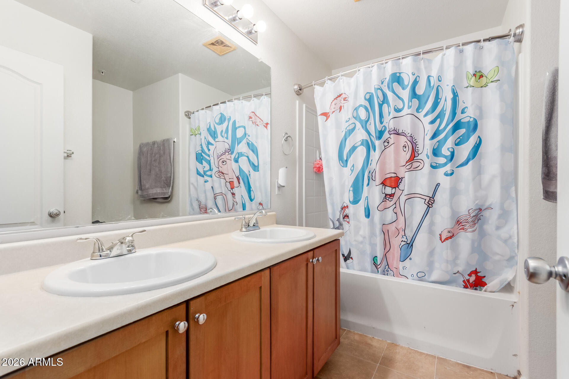 1265 South Aaron, Unit 346 Mesa, AZ 85209 - Photo 16 of 34 a bathroom with a sink a mirror and a shower curtain